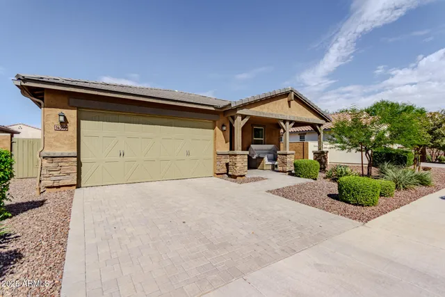 a front view of a house with a yard and garage