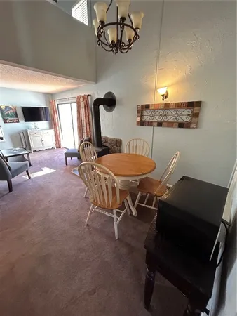 a dining room with furniture and chandelier