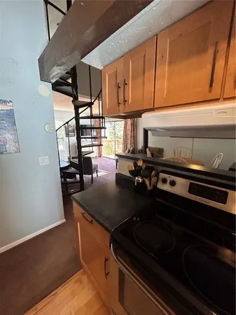 a kitchen with granite countertop a stove and a sink