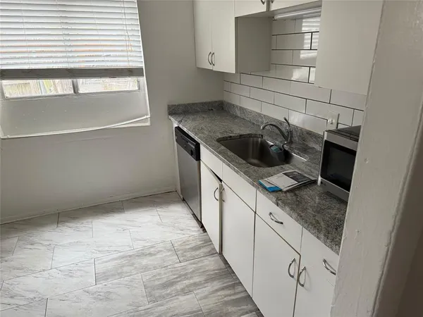 a kitchen with a sink and cabinets