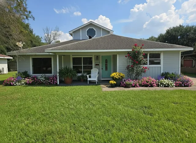 a front view of a house with garden