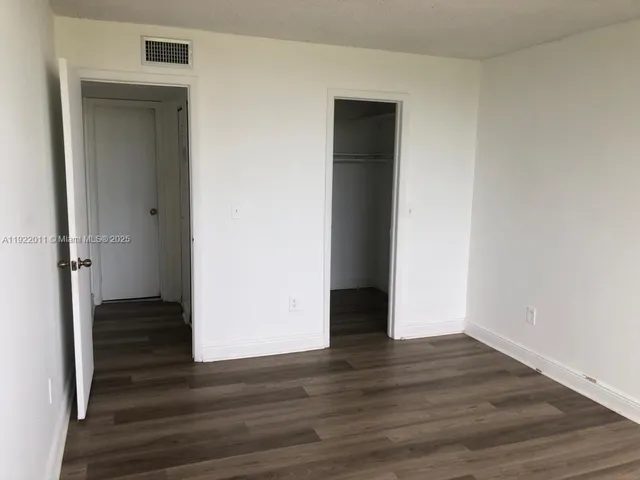 a view of wooden floor and closet