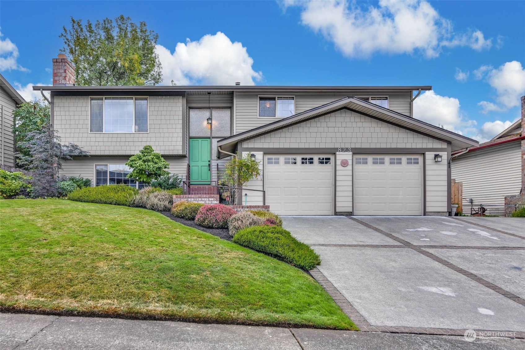 823 South 28th Court Renton, WA 98055 - Photo 1 of 37 a front view of a house with a yard and garage