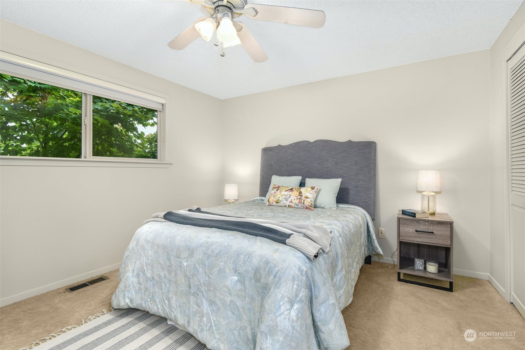 823 South 28th Court Renton, WA 98055 - Photo 14 of 37 a bed room with a bed and a chandelier