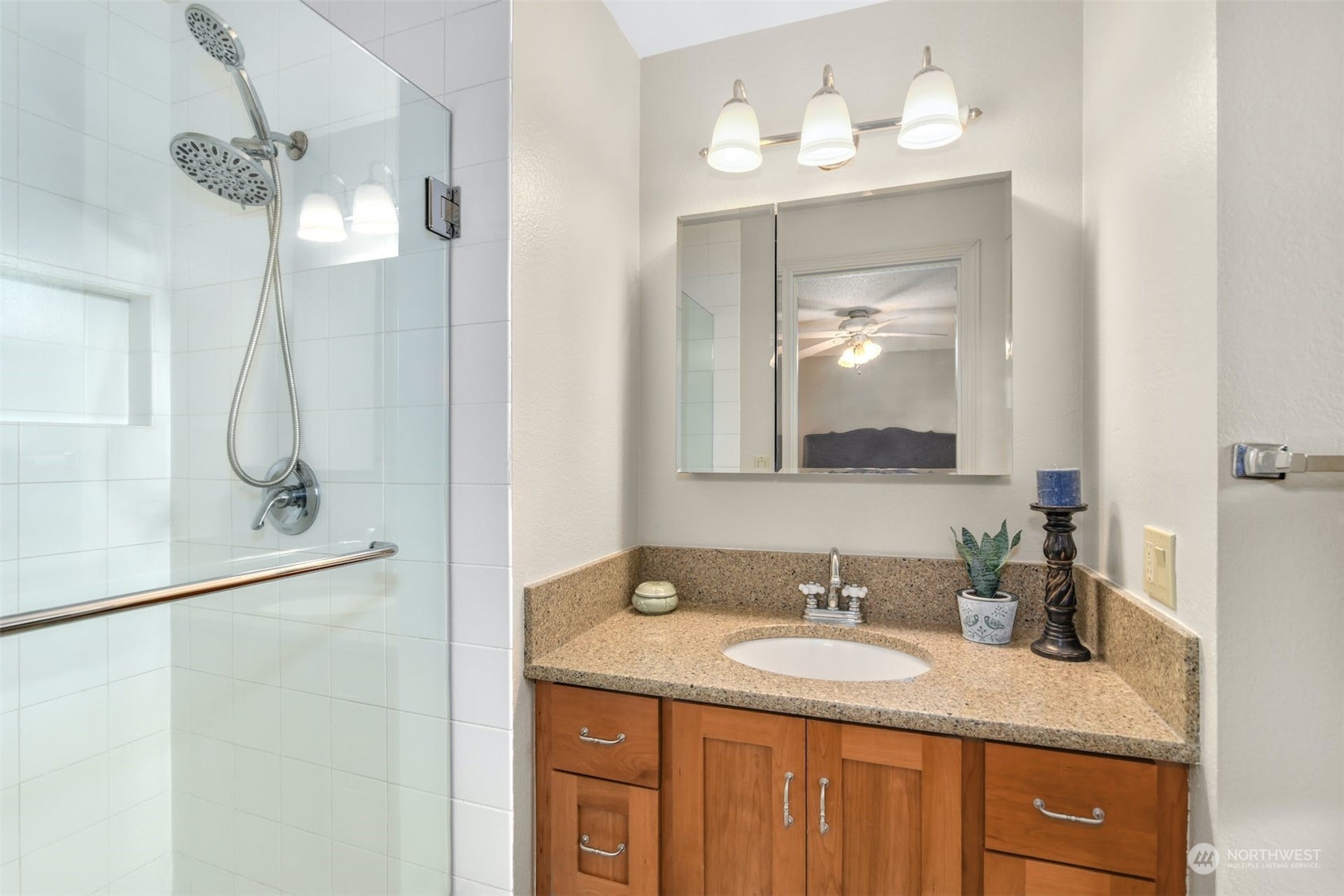 823 South 28th Court Renton, WA 98055 - Photo 16 of 37 a bathroom with a granite countertop sink a mirror and a shower