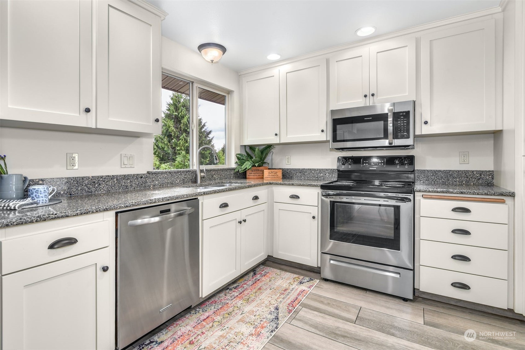 823 South 28th Court Renton, WA 98055 - Photo 8 of 37 a kitchen with granite countertop white cabinets white stainless steel appliances with a sink and dishwasher