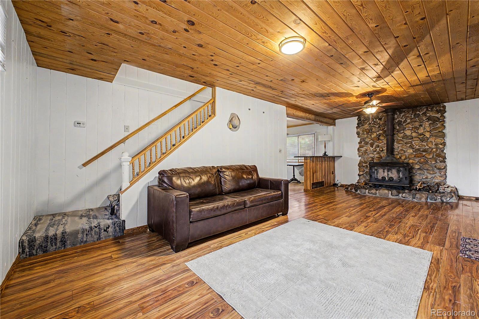 145 Bailey Drive Bailey, CO 80421 - Photo 7 of 31 a living room with furniture and a wooden floor
