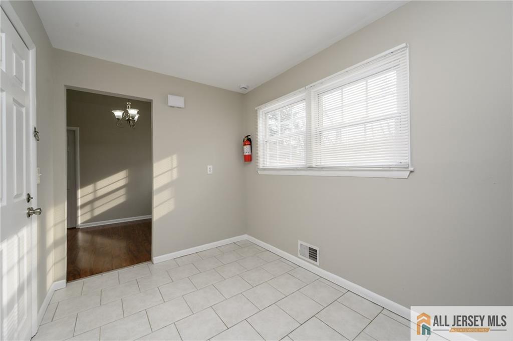 691 Inman Avenue Colonia, NJ 07067 - Photo 11 of 32 an empty room with windows
