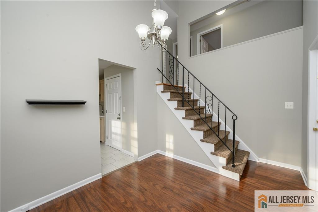 691 Inman Avenue Colonia, NJ 07067 - Photo 14 of 32 a view of entryway and hall with wooden floor