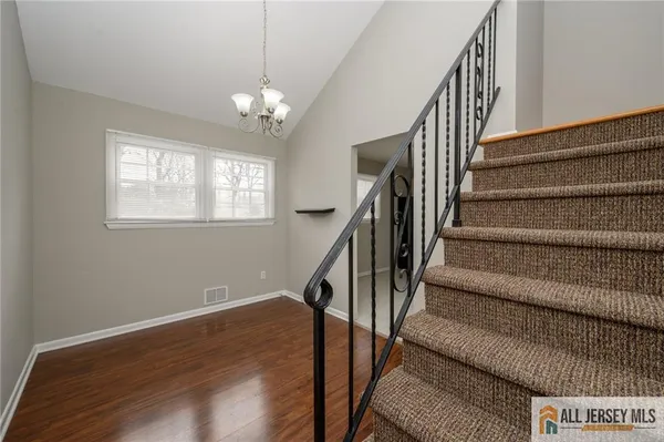 a view of staircase with wooden floor and fan