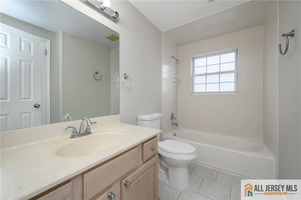 691 Inman Avenue Colonia, NJ 07067 - Photo 18 of 32 a bathroom with a sink a toilet and shower