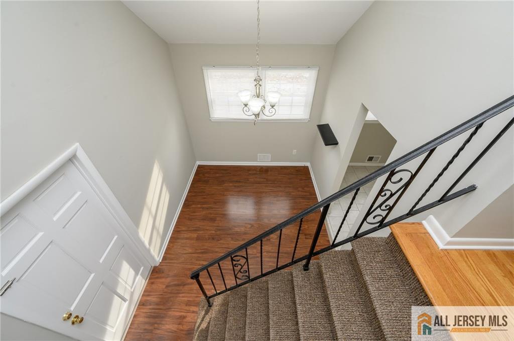691 Inman Avenue Colonia, NJ 07067 - Photo 24 of 32 a view of entryway and hall with wooden floor