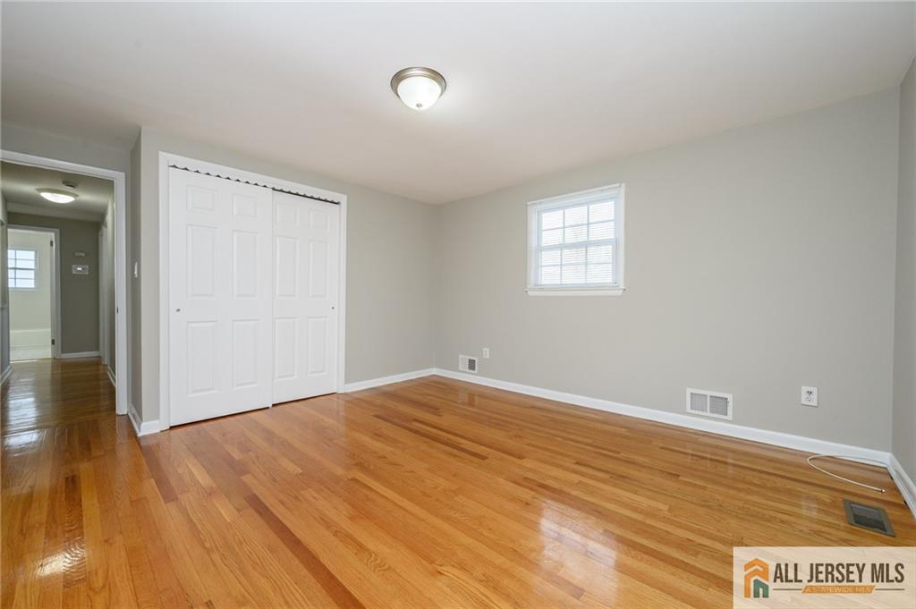 691 Inman Avenue Colonia, NJ 07067 - Photo 26 of 32 a view of an empty room and wooden floor