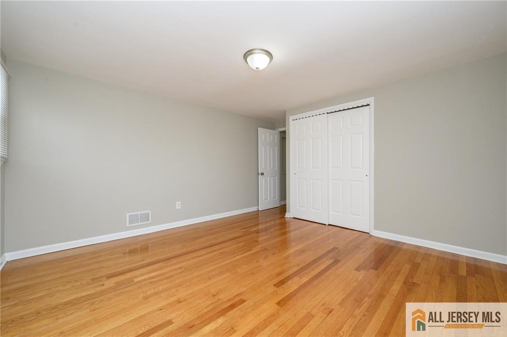 691 Inman Avenue Colonia, NJ 07067 - Photo 27 of 32 a view of an empty room with wooden floor and a window