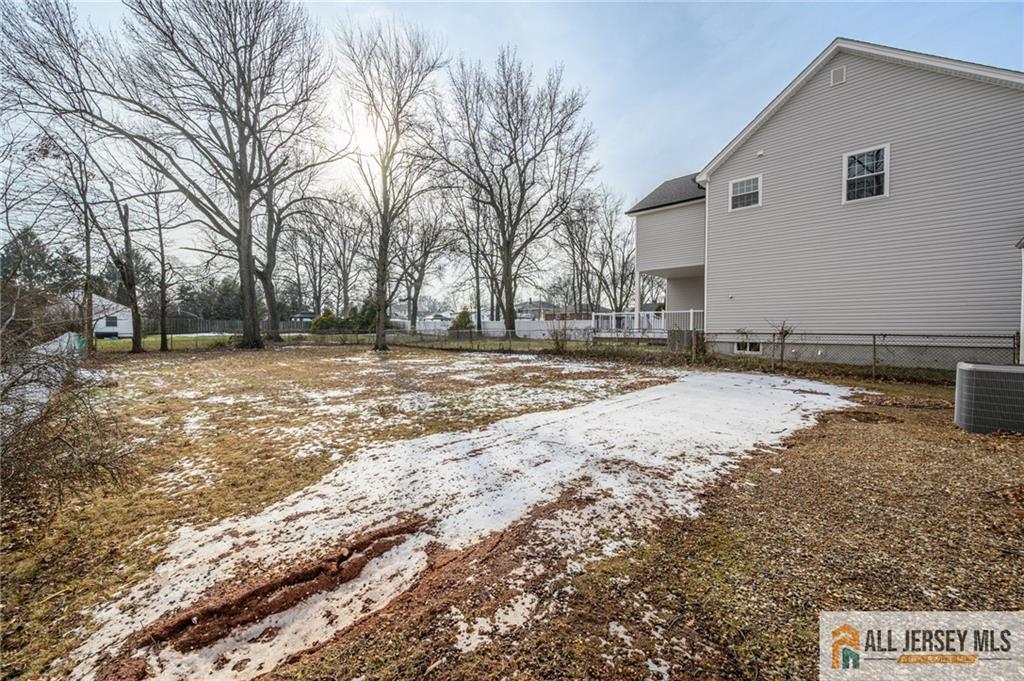 691 Inman Avenue Colonia, NJ 07067 - Photo 32 of 32 a view of a backyard with wooden fence