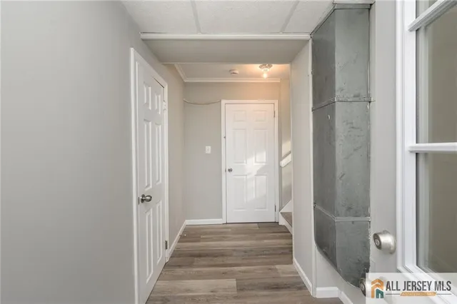 a view of a hallway with a wooden door