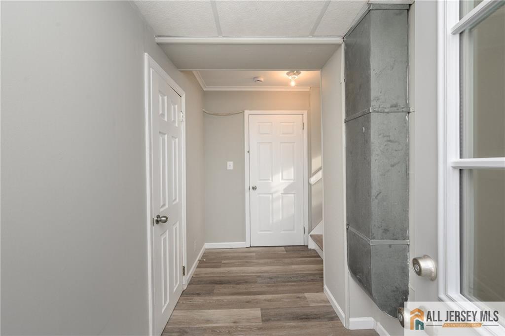 691 Inman Avenue Colonia, NJ 07067 - Photo 4 of 32 a view of a hallway with a wooden door