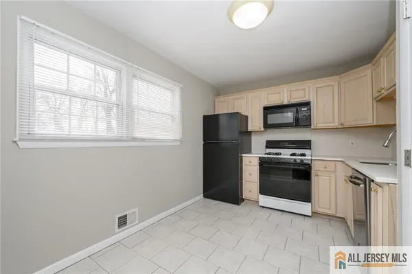 a kitchen with stainless steel appliances a refrigerator stove and microwave