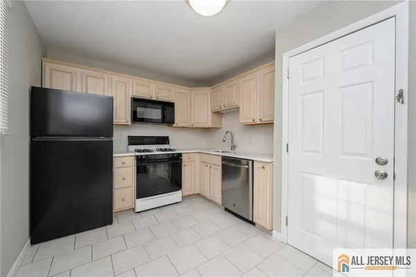 a kitchen with a refrigerator stove and a sink