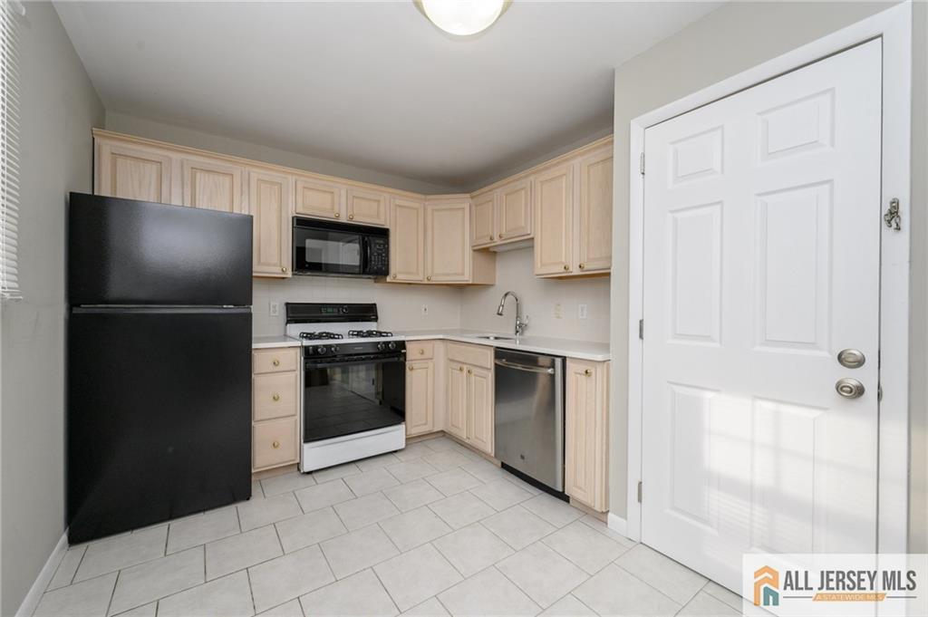 691 Inman Avenue Colonia, NJ 07067 - Photo 8 of 32 a kitchen with a refrigerator stove and a sink