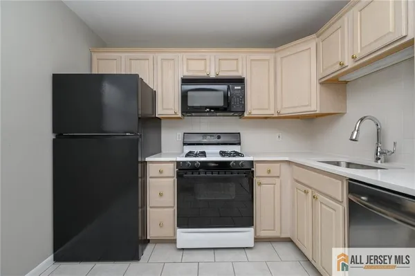 a kitchen with a sink stove and refrigerator