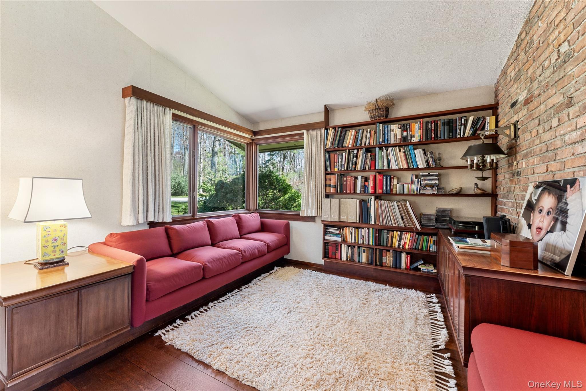 98 Cushman Road Scarsdale, NY 10583 - Photo 7 of 43 a living room with furniture a bookshelf and a window