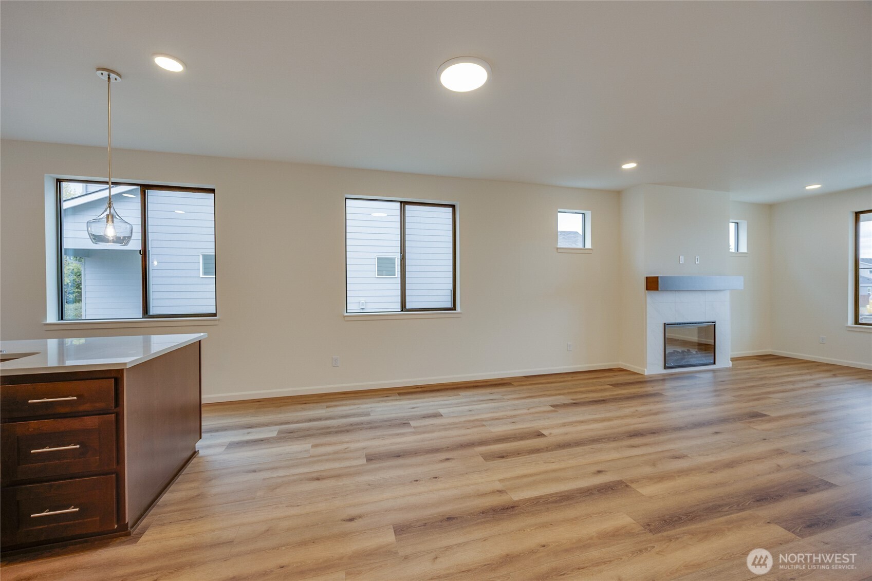 950 RW Fletcher Street Winlock, WA 98596 - Photo 14 of 40 an empty room with wooden floor cabinet and windows