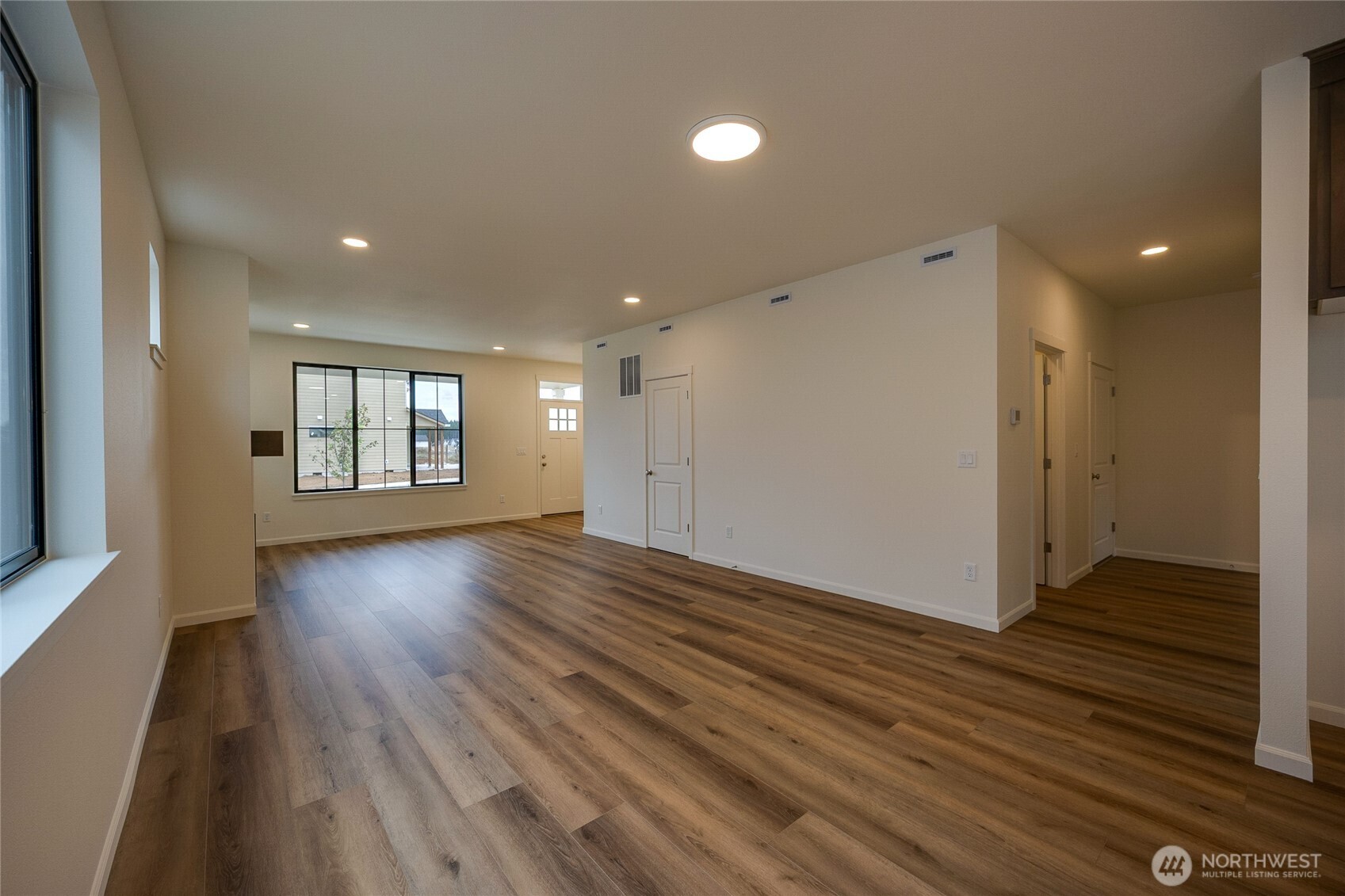 950 RW Fletcher Street Winlock, WA 98596 - Photo 15 of 40 an empty room with wooden floor and windows