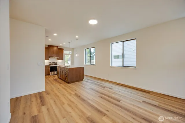 a kitchen with stainless steel appliances kitchen island wooden cabinets and granite counter tops