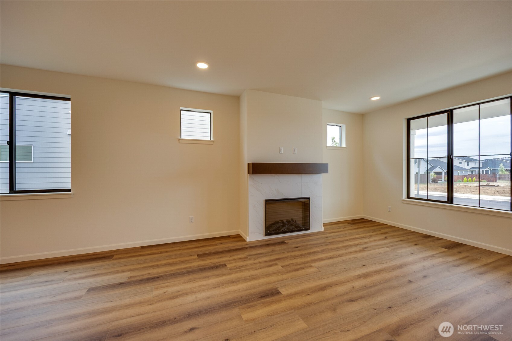 950 RW Fletcher Street Winlock, WA 98596 - Photo 17 of 40 a view of empty room with wooden floor and fireplace