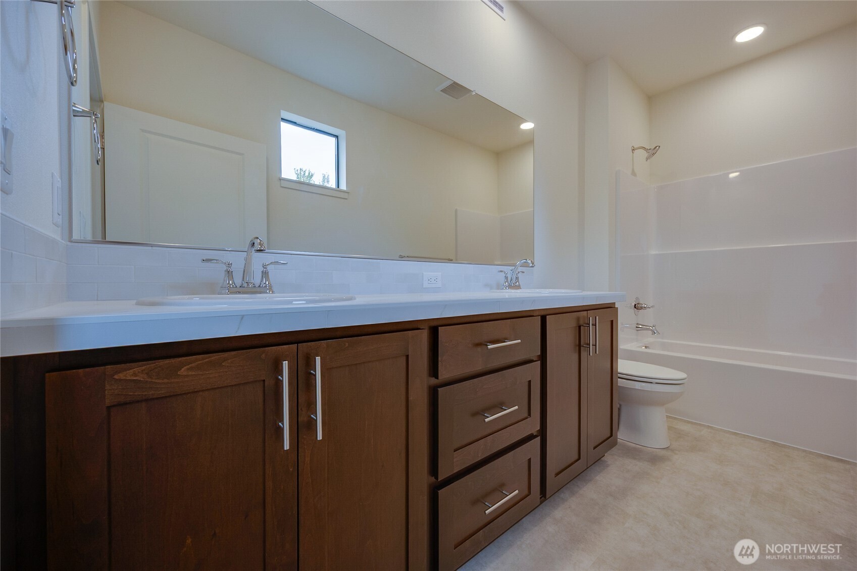 950 RW Fletcher Street Winlock, WA 98596 - Photo 22 of 40 a bathroom with a granite countertop sink a toilet a shower and a mirror