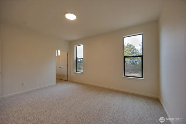 an empty room with windows and closet