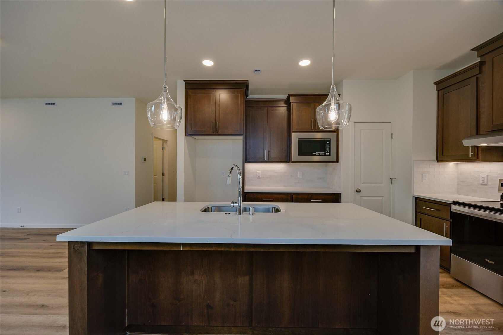950 RW Fletcher Street Winlock, WA 98596 - Photo 9 of 40 a kitchen with kitchen island a sink appliances and cabinets
