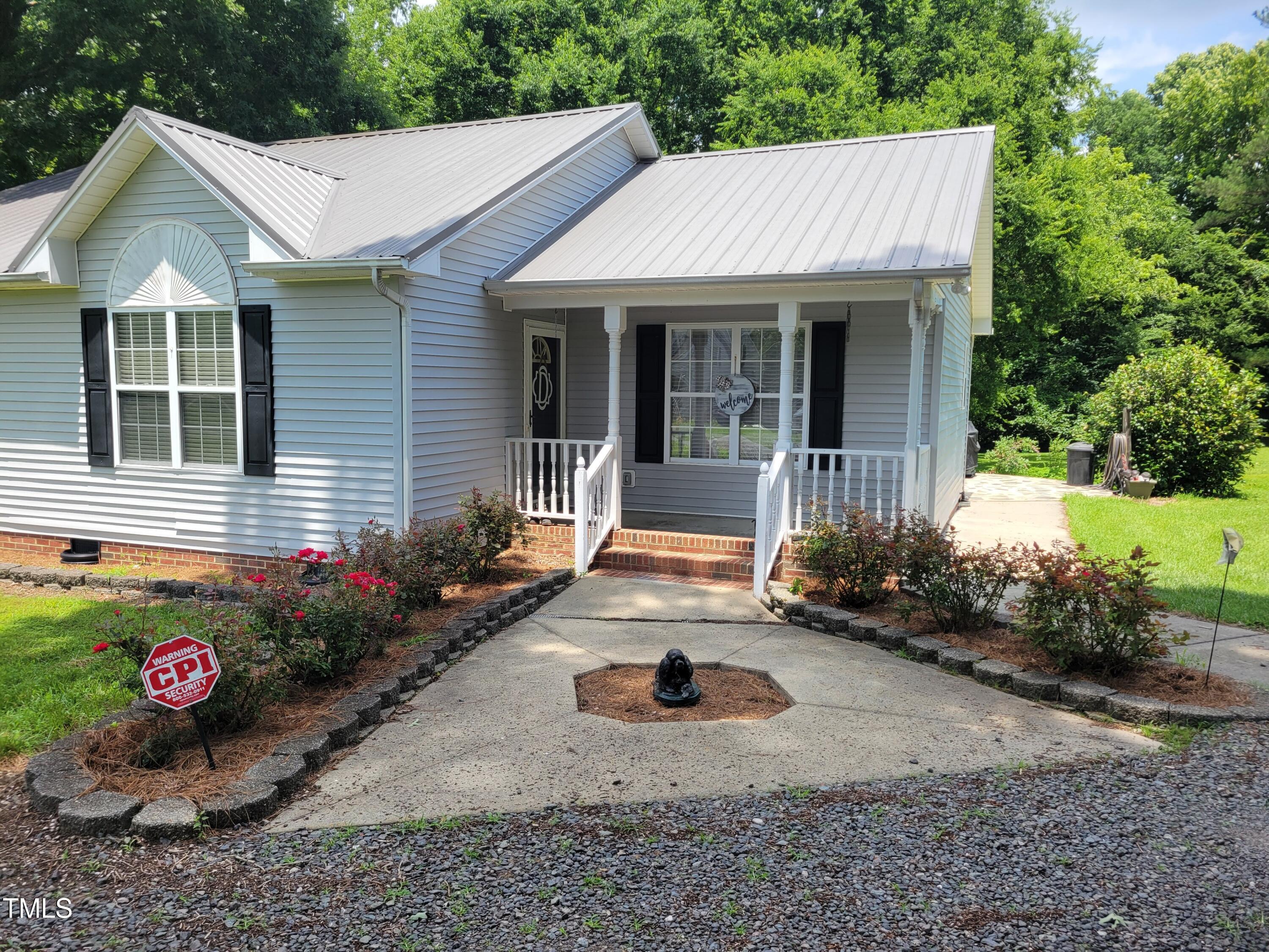 78 Phil Johnson Road Sanford, NC 27330 - Photo 14 of 47 a front view of a house with garden