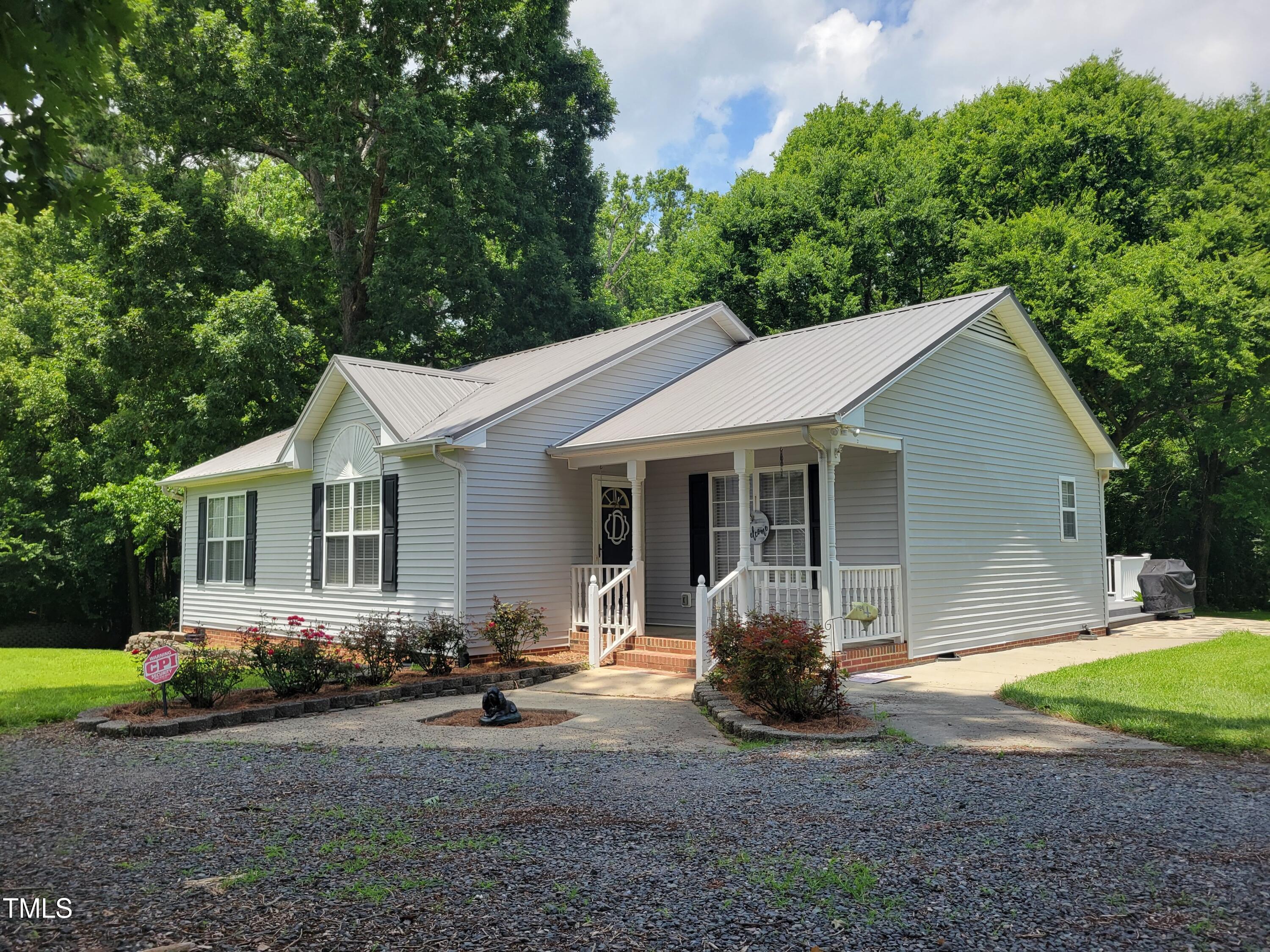 78 Phil Johnson Road Sanford, NC 27330 - Photo 4 of 47 a front view of a house with garden