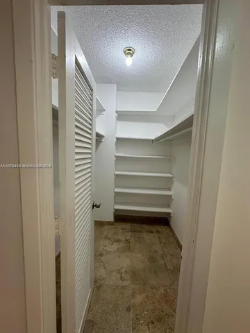 a front view of a house with swimming pool and outdoor seating