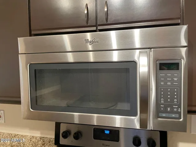 a kitchen with stainless steel appliances granite countertop a sink and a stove