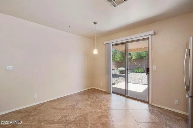 a view of an empty room with a ceiling fan