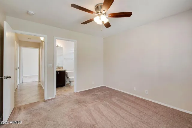 a bathroom with a granite countertop toilet a sink and a mirror