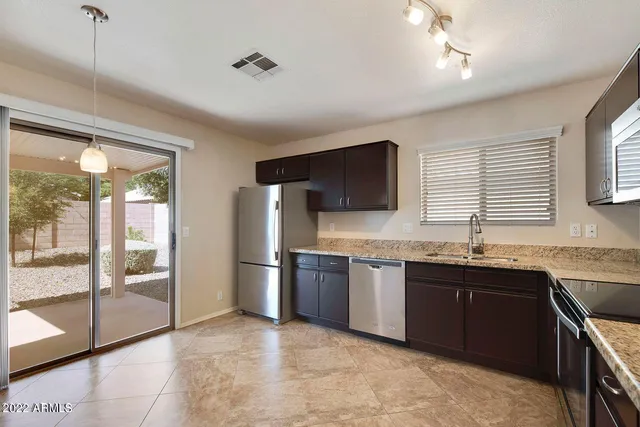 a large kitchen with cabinets and stainless steel appliances