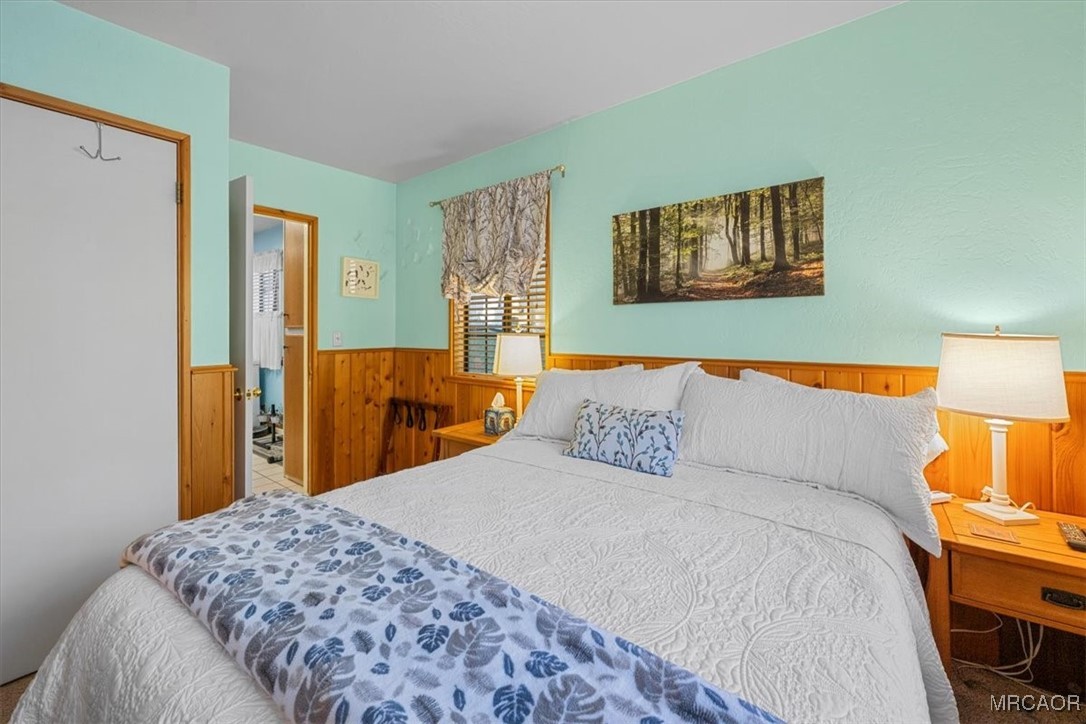 446 Moreno Lane Sugarloaf, CA 92386 - Photo 17 of 41 a bedroom with a bed and lamp