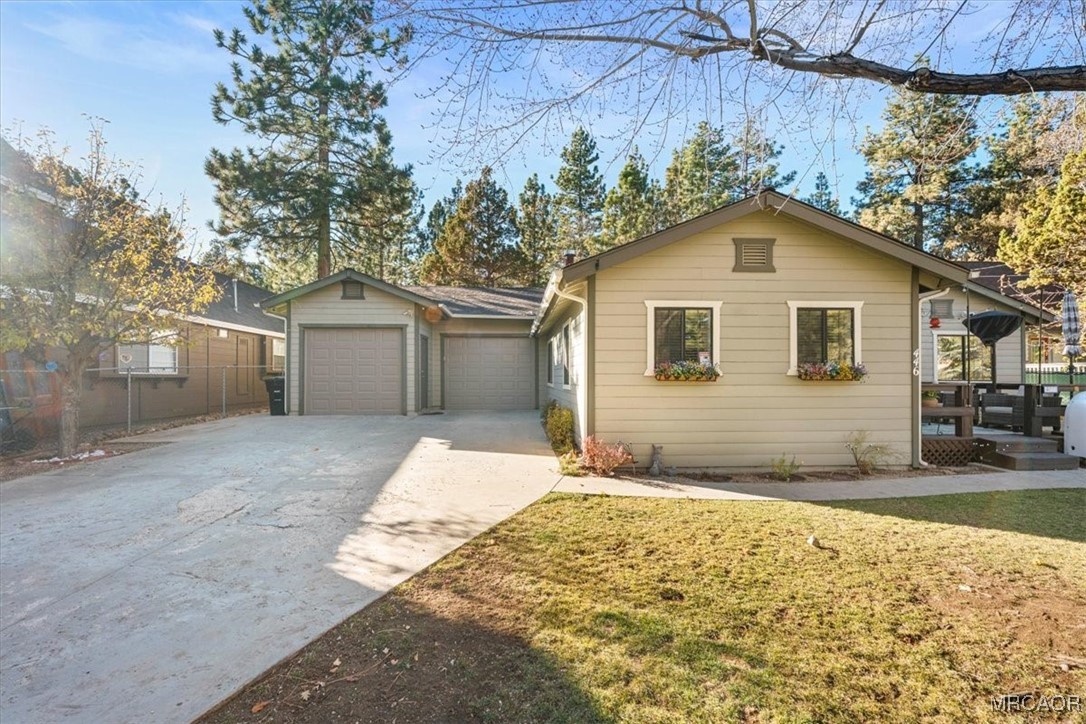 446 Moreno Lane Sugarloaf, CA 92386 - Photo 3 of 41 a front view of a house with a yard and garage