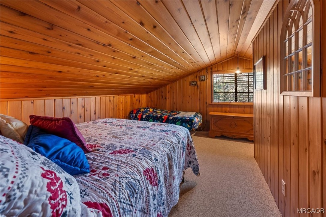 446 Moreno Lane Sugarloaf, CA 92386 - Photo 31 of 41 a bed sitting in a spacious bedroom next to a window