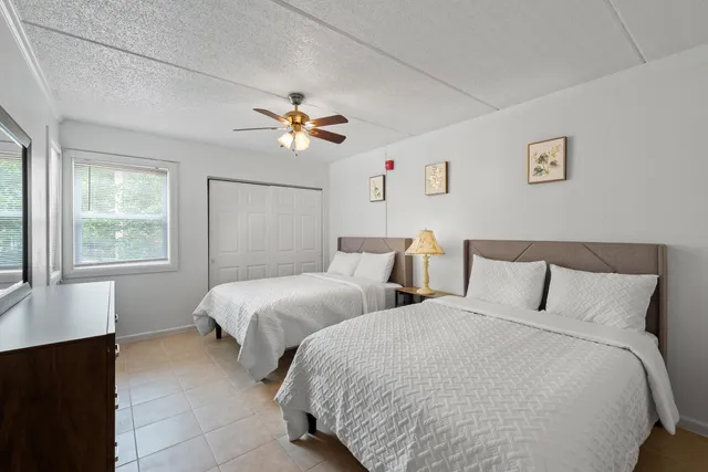 a bedroom with two beds and a window