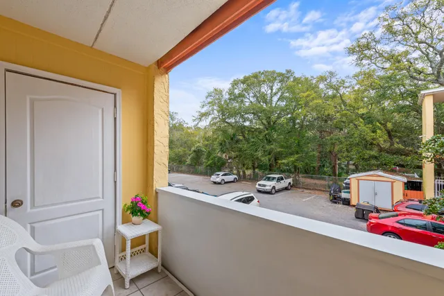 a balcony with table and chairs