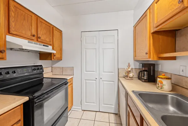 a kitchen with a sink stove and cabinets
