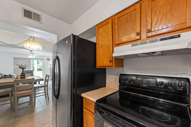 a kitchen with wooden cabinets and stainless steel appliances