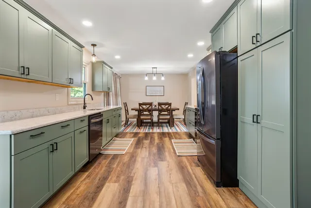 a view of a kitchen with a sink and wooden floor