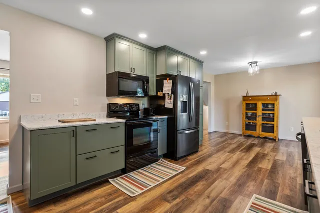 a kitchen with stainless steel appliances a refrigerator and a stove top oven