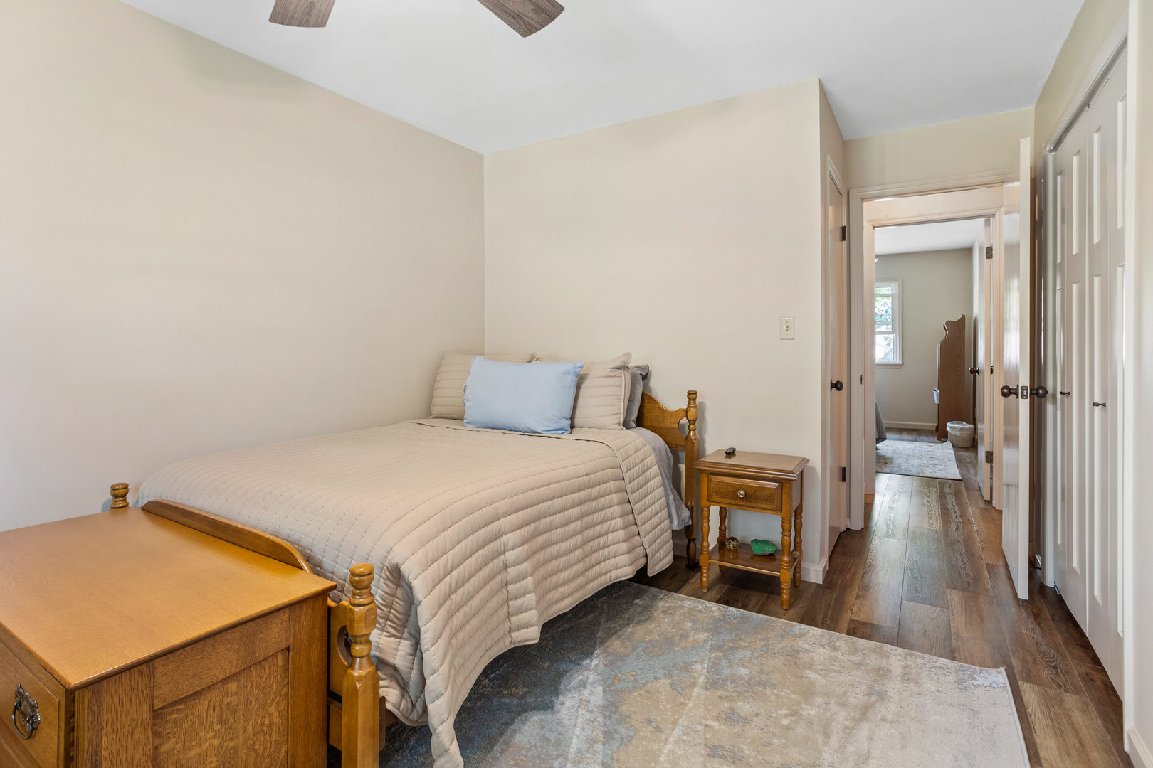 24 Crestview Court Fisher, IL 61843 - Photo 21 of 42 a bedroom with a bed and a table with wooden floor